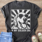 Dark grey t-shirt with a distressed graphic of a golden retriever wearing sunglasses and the text "IN MY GOLDEN ERA".