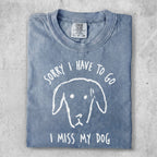 Blue t-shirt with "Sorry I have to go I miss my dog" text and dog illustration.