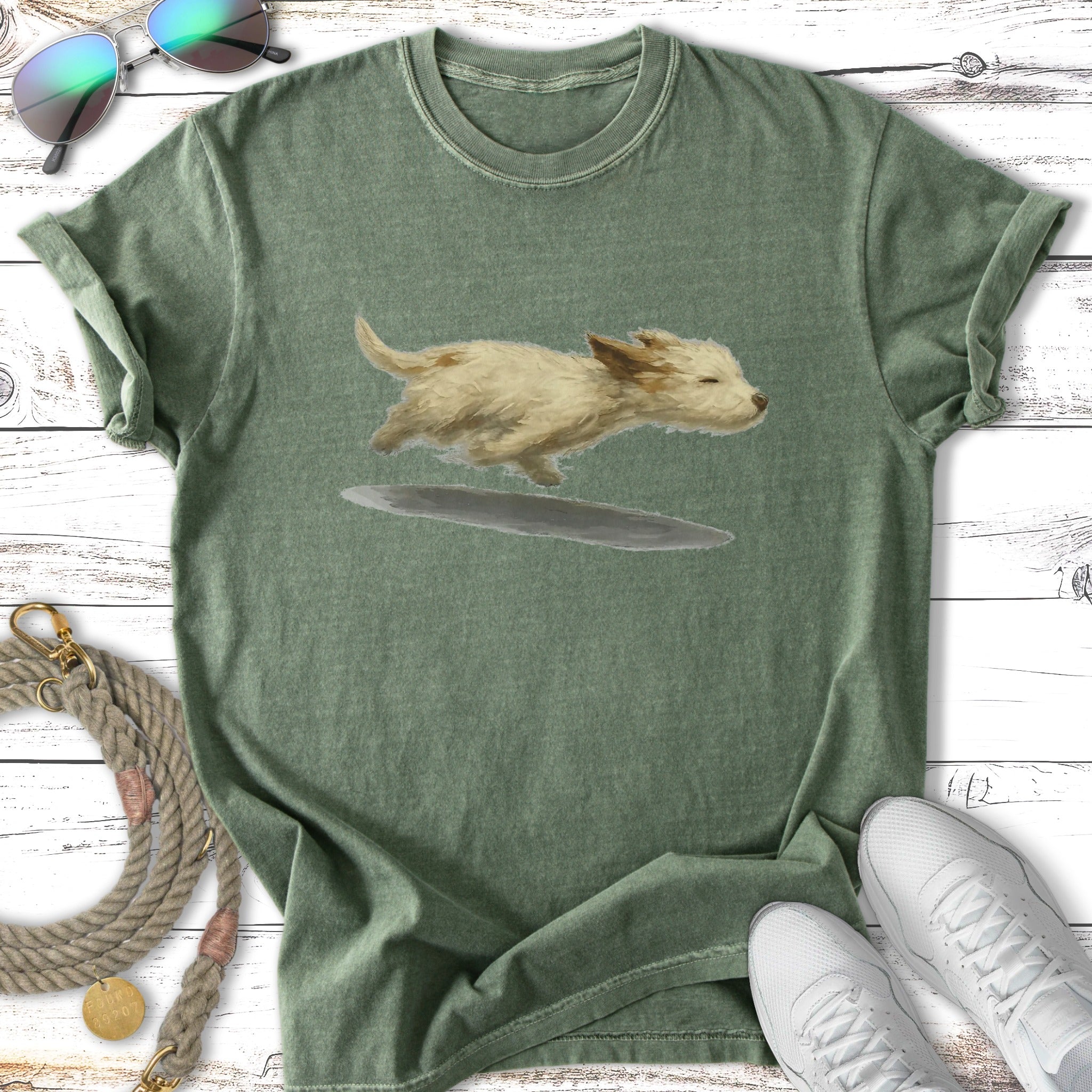 T-shirt with a watercolor illustration of a small, tan dog running.