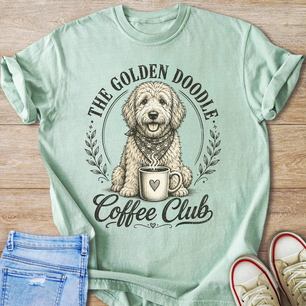 Golden Doodle wearing bandana sits with coffee mug, text "The Golden Doodle Coffee Club".