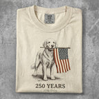 Golden retriever holding American flag, "250 YEARS 1776-2026" text.