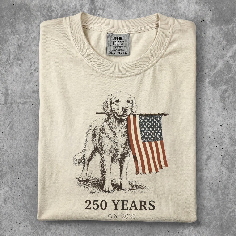 Golden retriever holding American flag, "250 YEARS 1776-2026" text.