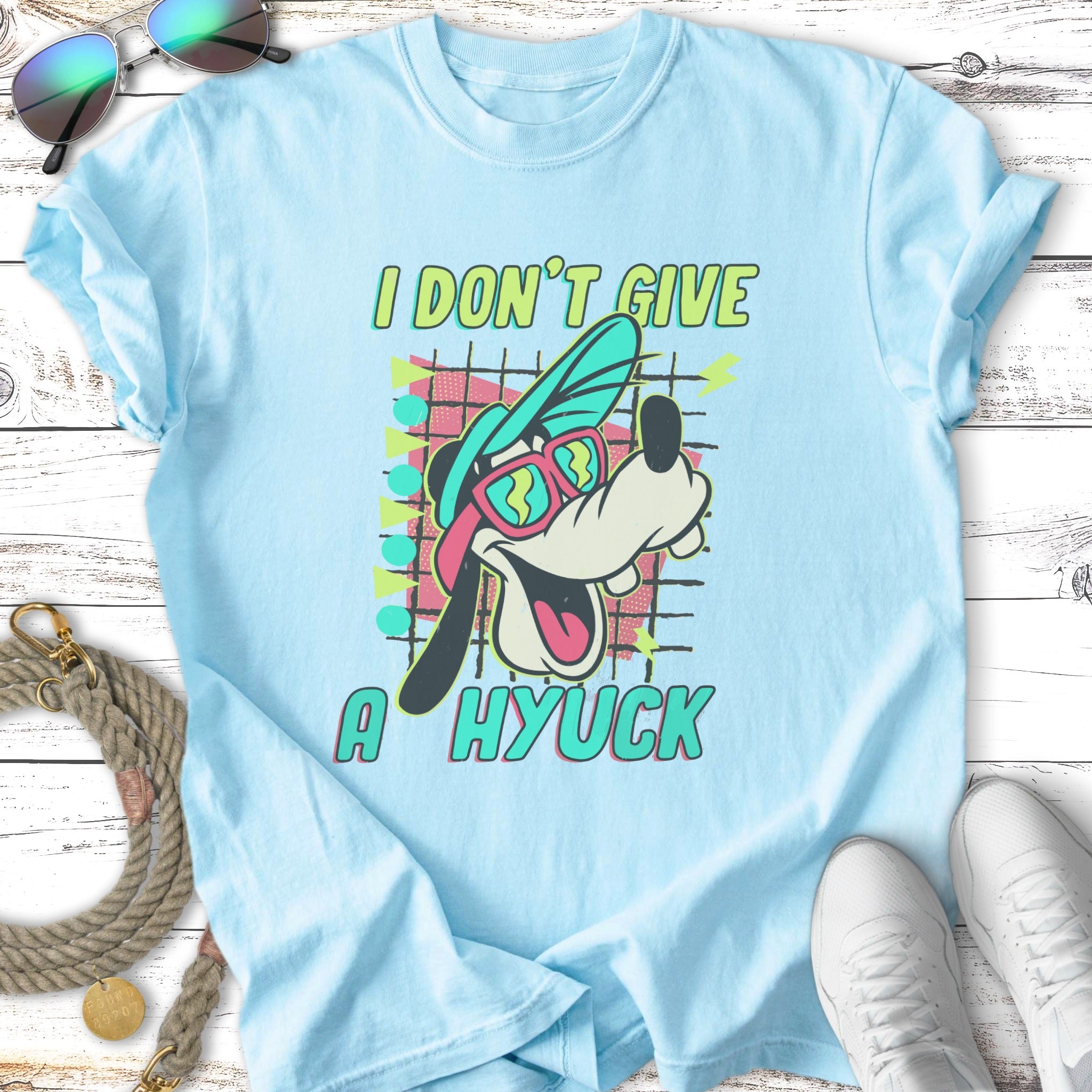 Light blue t-shirt with Goofy wearing sunglasses and saying "I DON'T GIVE A HYUCK".