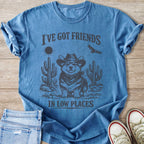 Corgi in cowboy hat and bandana with cacti, sun, and eagle. "I've got friends in low places."