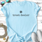 Light blue t-shirt with "treat dealer" and a paw print logo.