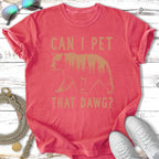 Coral t-shirt with a bear silhouette and forest, "Can I Pet That Dawg?" text.