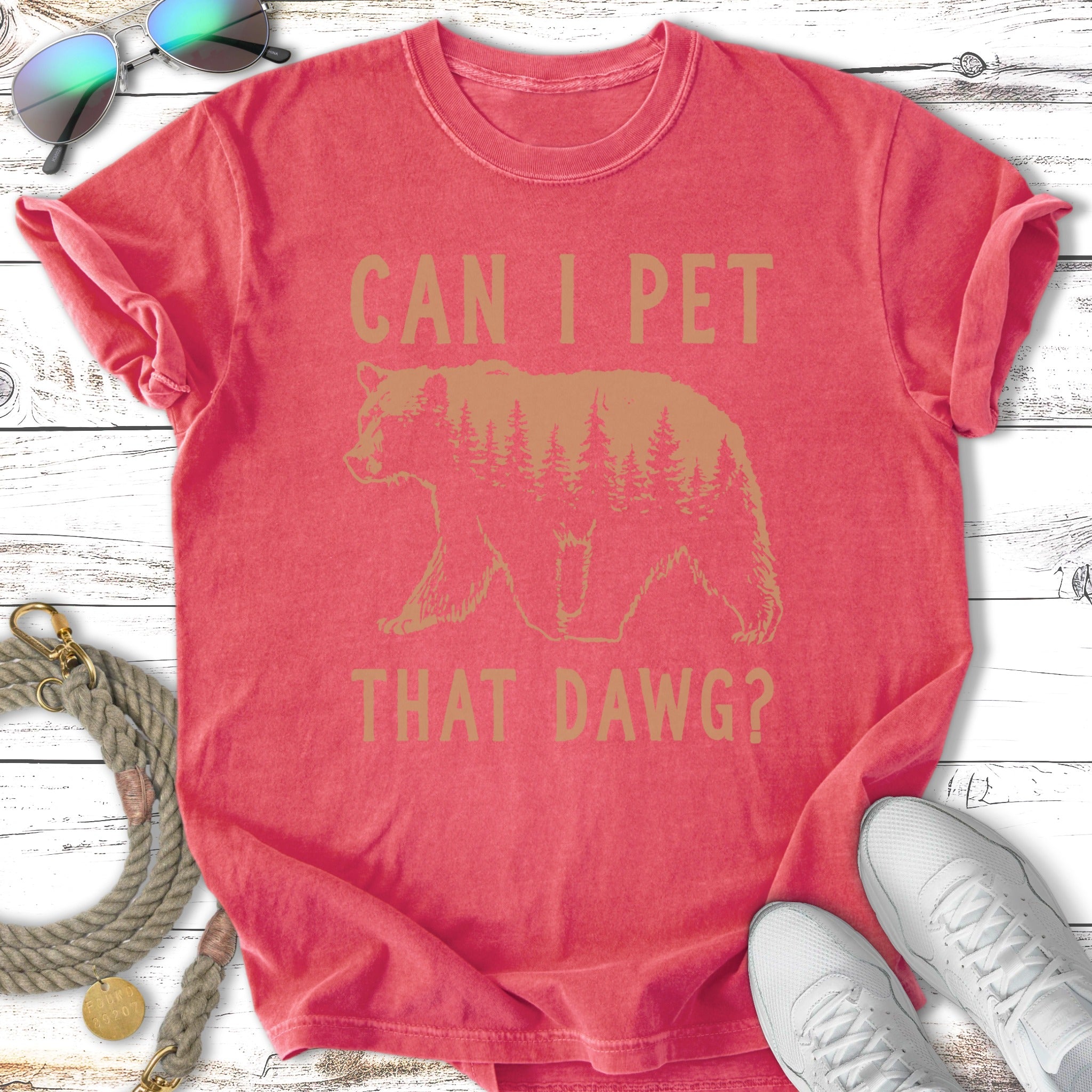 Coral t-shirt with a bear silhouette and forest, "Can I Pet That Dawg?" text.