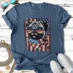 Pug wearing sunglasses and bandana in front of American flag.
