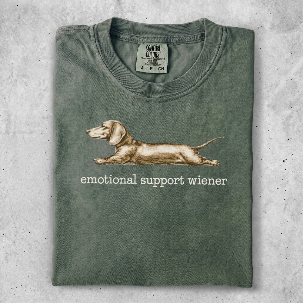 Green t-shirt with "Emotional Support Wiener" text and dachshund graphic.