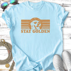 Light blue t-shirt with distressed graphic of a dog wearing sunglasses and text "STAY GOLDEN".