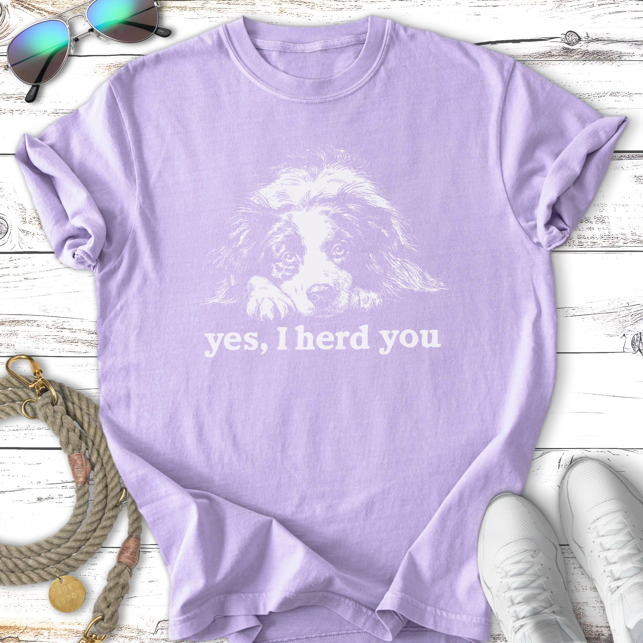 Lavender t-shirt with a white line drawing of a dog and text "yes, I herd you".