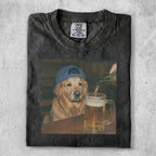 Black t-shirt with a golden retriever wearing a blue baseball cap and being poured a beer.