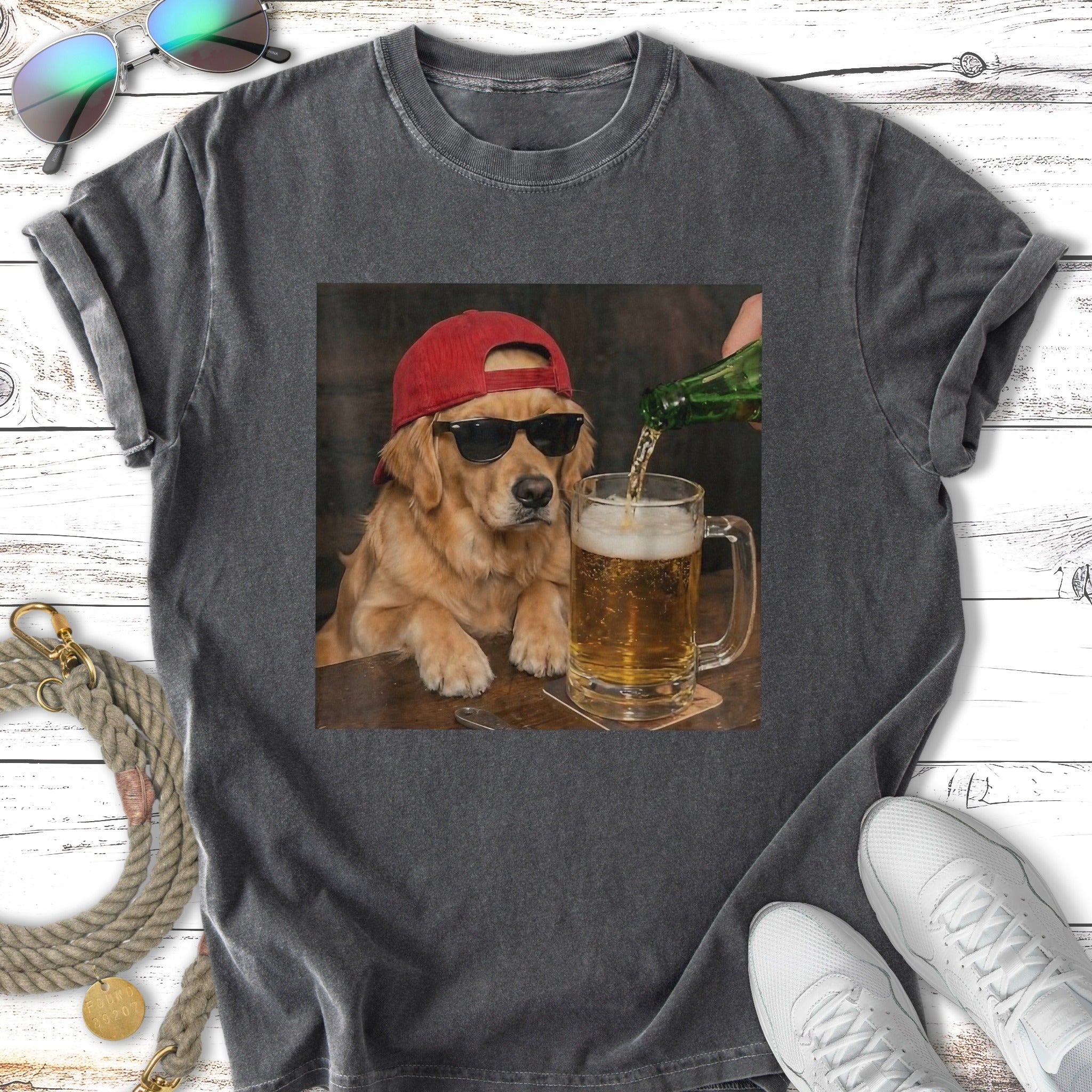 Golden retriever wearing sunglasses and red hat pours beer into mug.