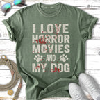 Green t-shirt with "I love horror movies and my dog" text and paw prints.