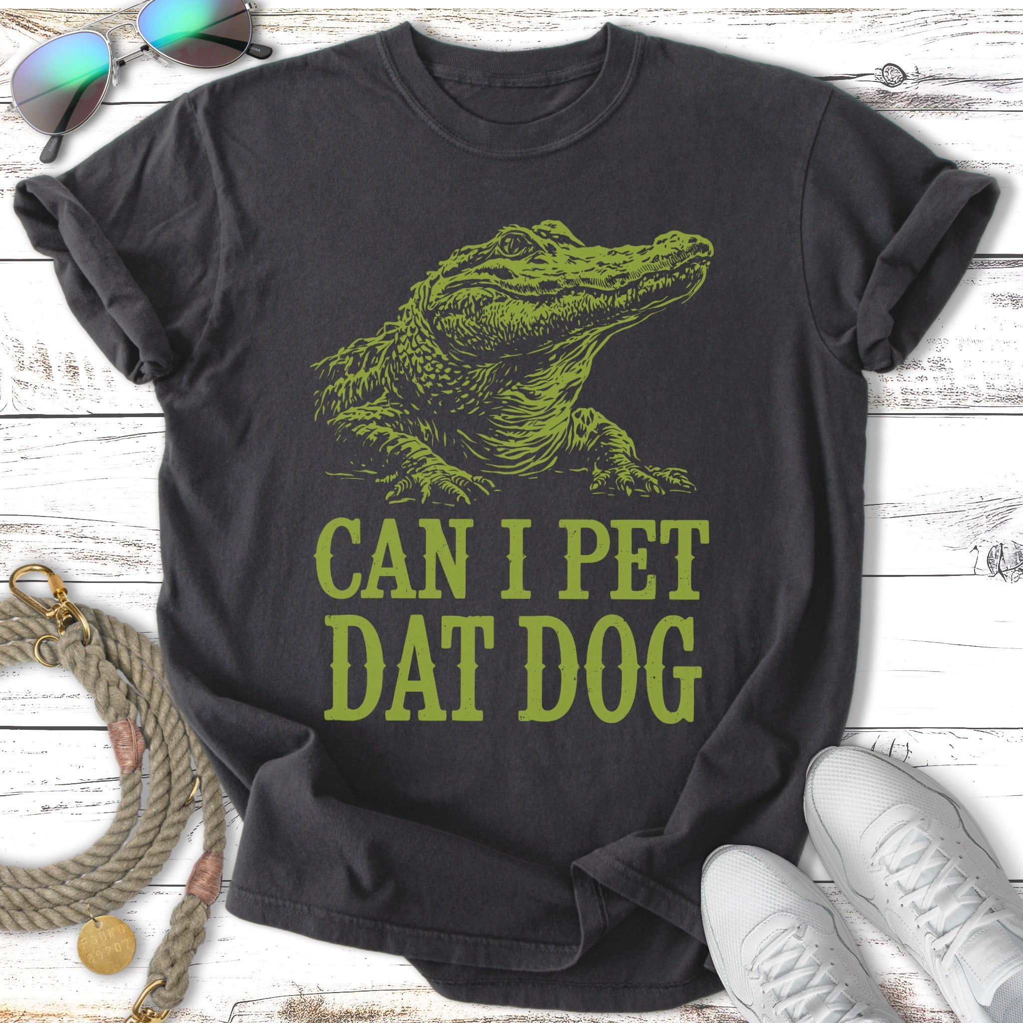 Dark t-shirt with green alligator graphic and text "CAN I PET DAT DOG".