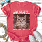 Red t-shirt with a cat's face and text "You're either a smart fella or a fart smella".