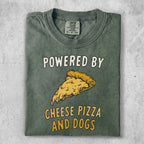 Green t-shirt with "Powered by Cheese Pizza and Dogs" text and pizza slice graphic.