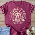 Crimson t-shirt with "Golden Retriever Swimming Club" design featuring a dog swimming.