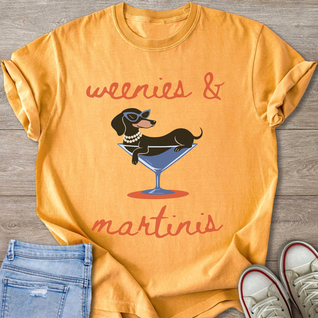 Orange t-shirt with dachshund in martini glass graphic and "weenies & martinis" text.