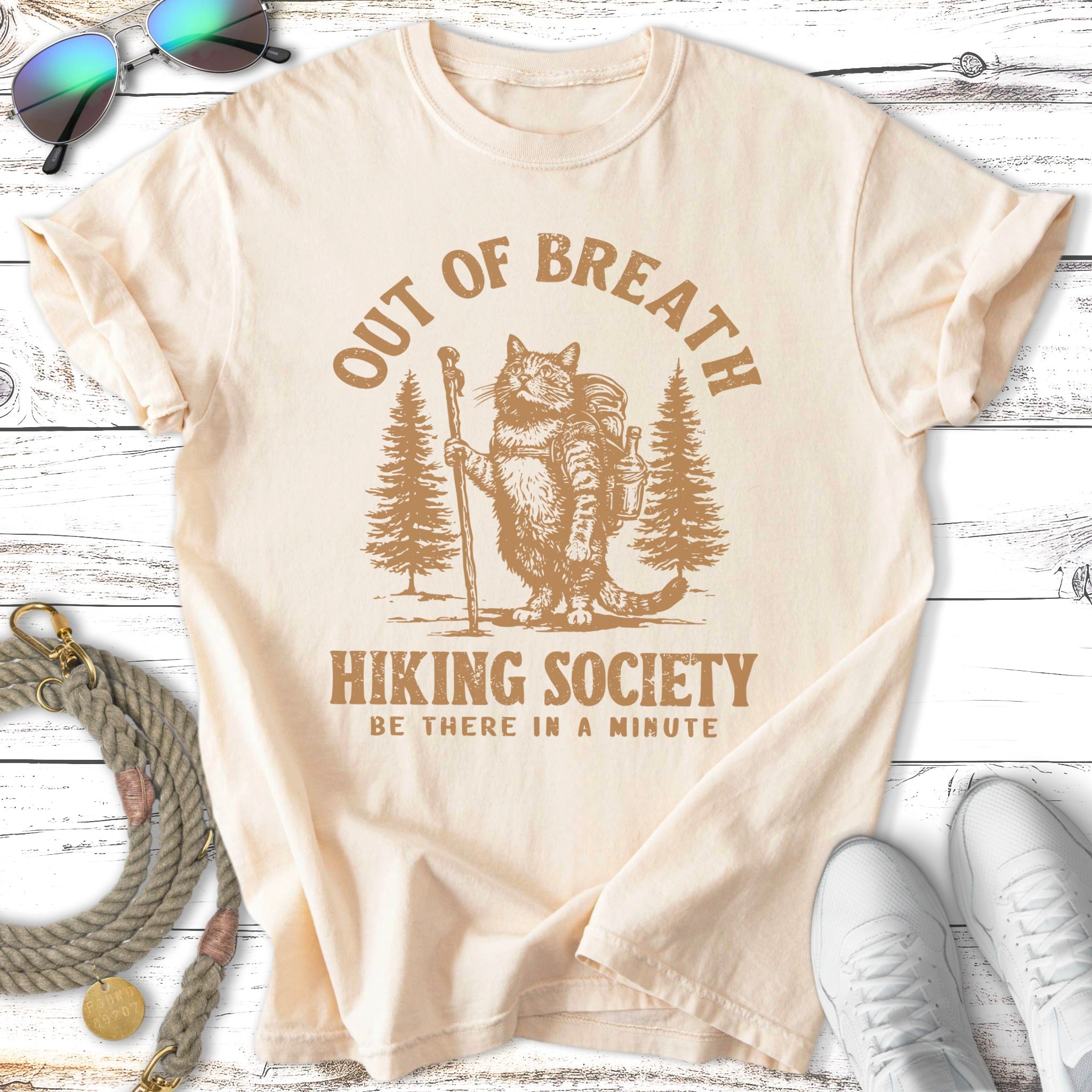 Cream t-shirt with "Out of Breath Hiking Society" text and hiking cat graphic.