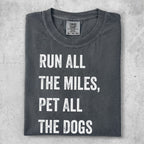Dark grey t-shirt with white text "RUN ALL THE MILES, PET ALL THE DOGS".