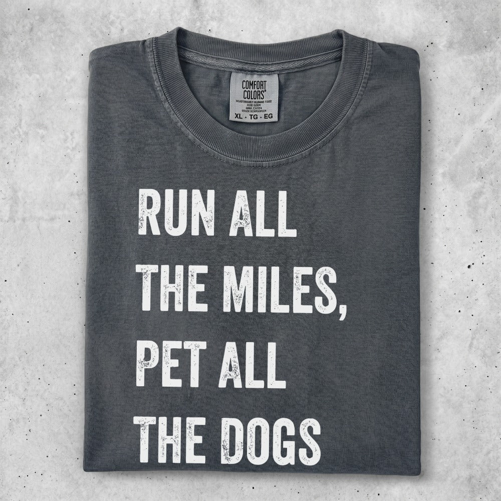 Dark grey t-shirt with white text "RUN ALL THE MILES, PET ALL THE DOGS".
