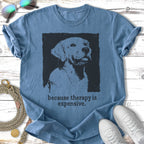 Distressed screen-print of a dog's head on a blue t-shirt, with "because therapy is expensive."