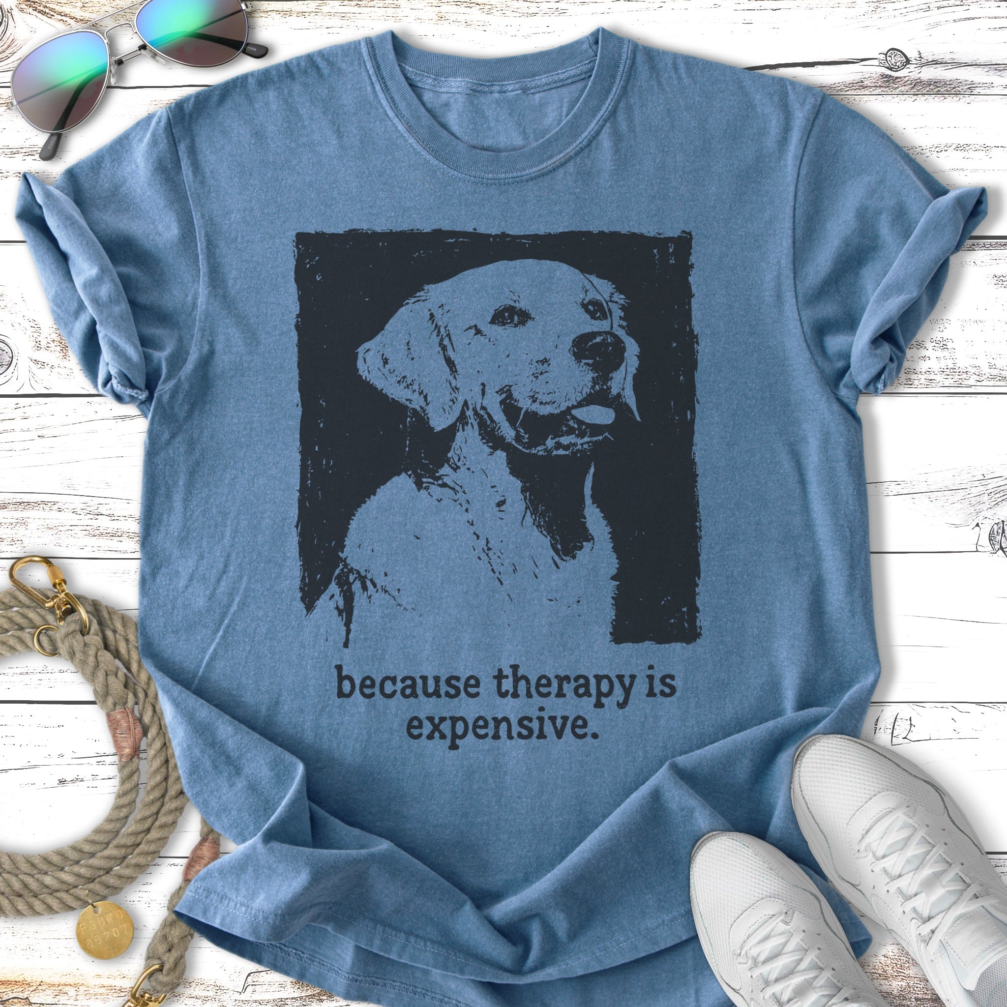 Distressed screen-print of a dog's head on a blue t-shirt, with "because therapy is expensive."