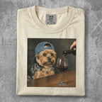 Yorkshire terrier wearing a blue cap being poured red wine into a glass.