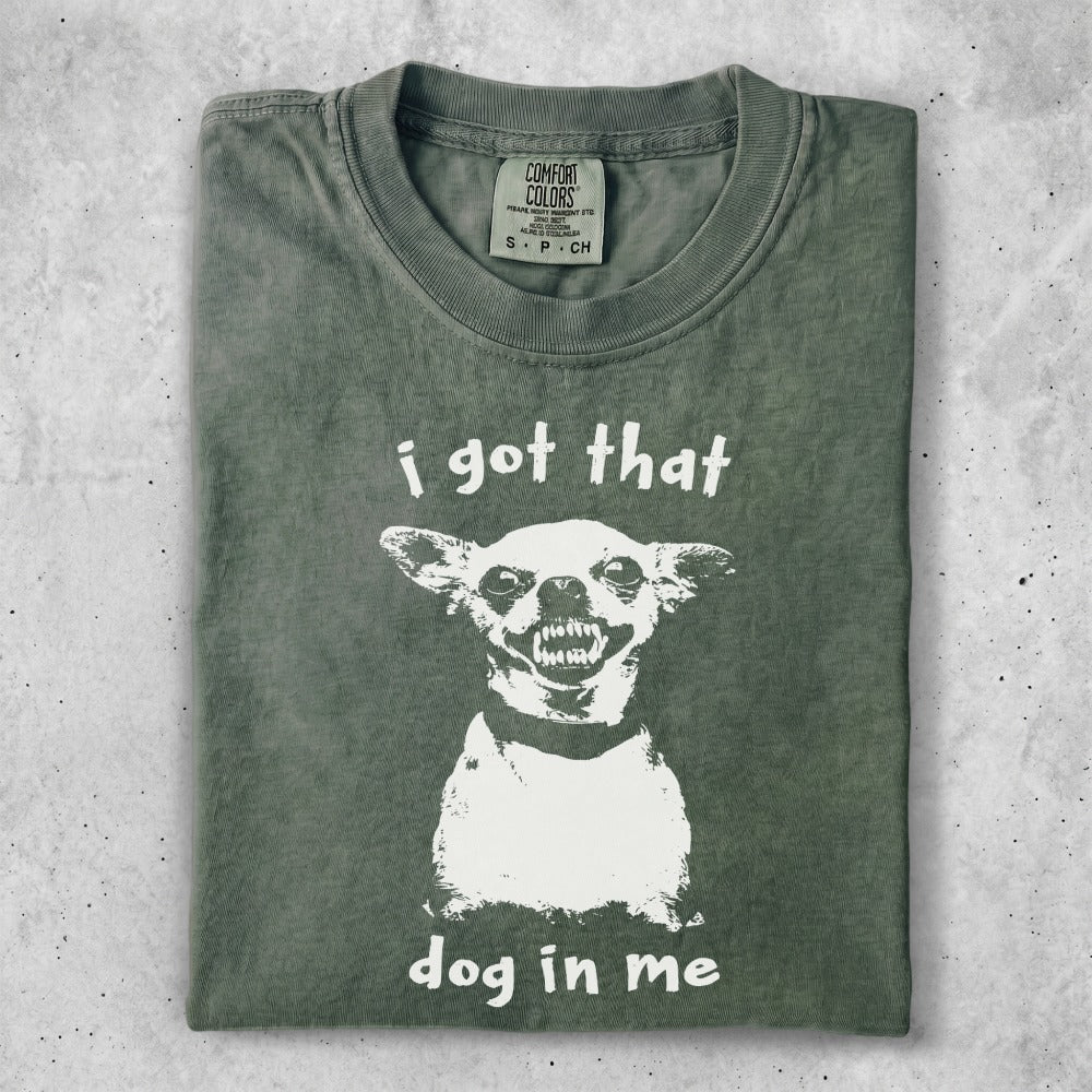 Green t-shirt with a graphic of a dog's head and the text "i got that dog in me".