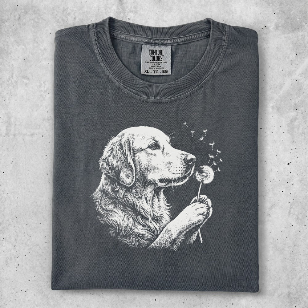 Golden Retriever sniffing a dandelion with seeds blowing in the wind.