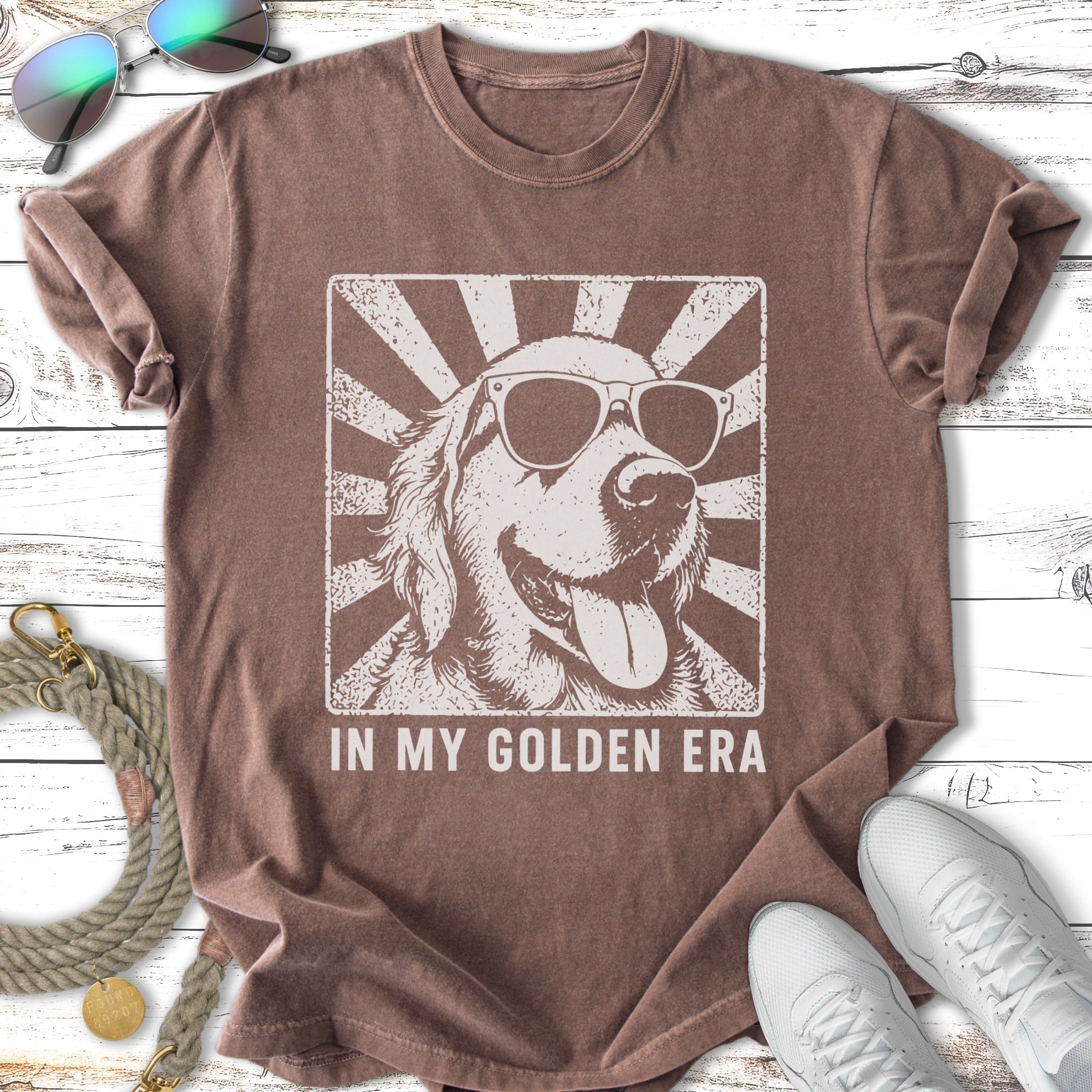 T-shirt featuring a vintage-style graphic of a golden retriever wearing sunglasses.