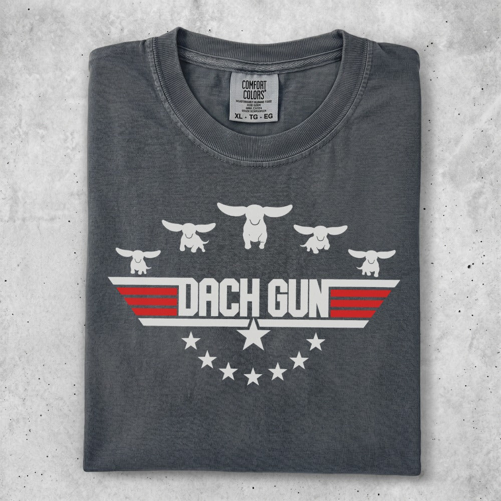 Gray t-shirt with "Dach Gun" text and dachshund silhouettes above stars.