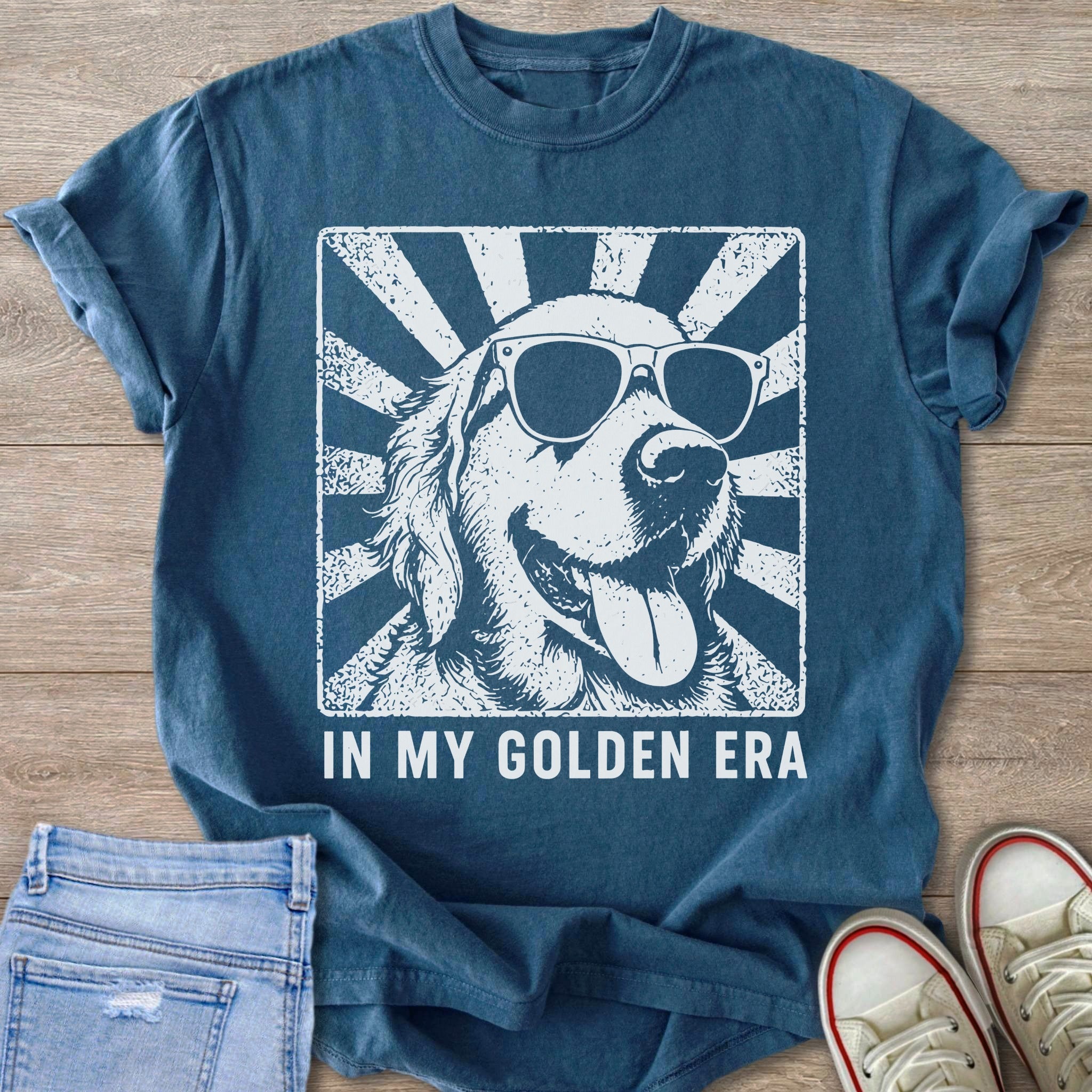 Blue t-shirt with white graphic of a smiling golden retriever wearing sunglasses.