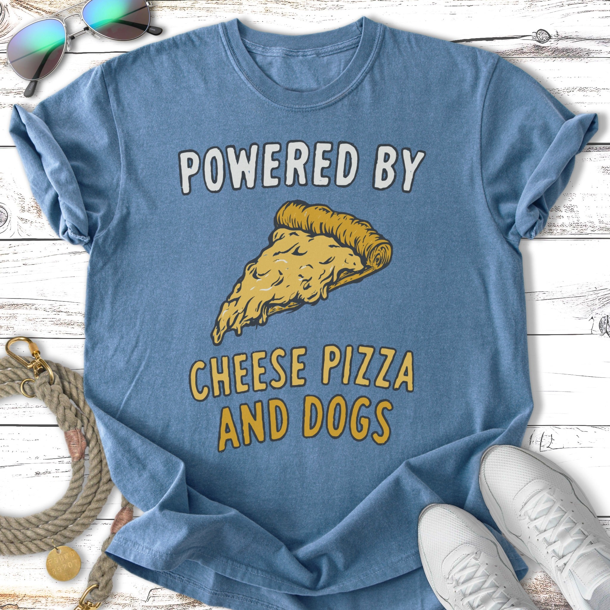 Blue t-shirt with text "POWERED BY CHEESE PIZZA AND DOGS" and pizza graphic.