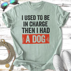 Light green t-shirt with black text "I USED TO BE IN CHARGE THEN I HAD A DOG".