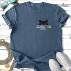 Blue t-shirt with a black cat peeking and text "JUDGING YOU SILENTLY".