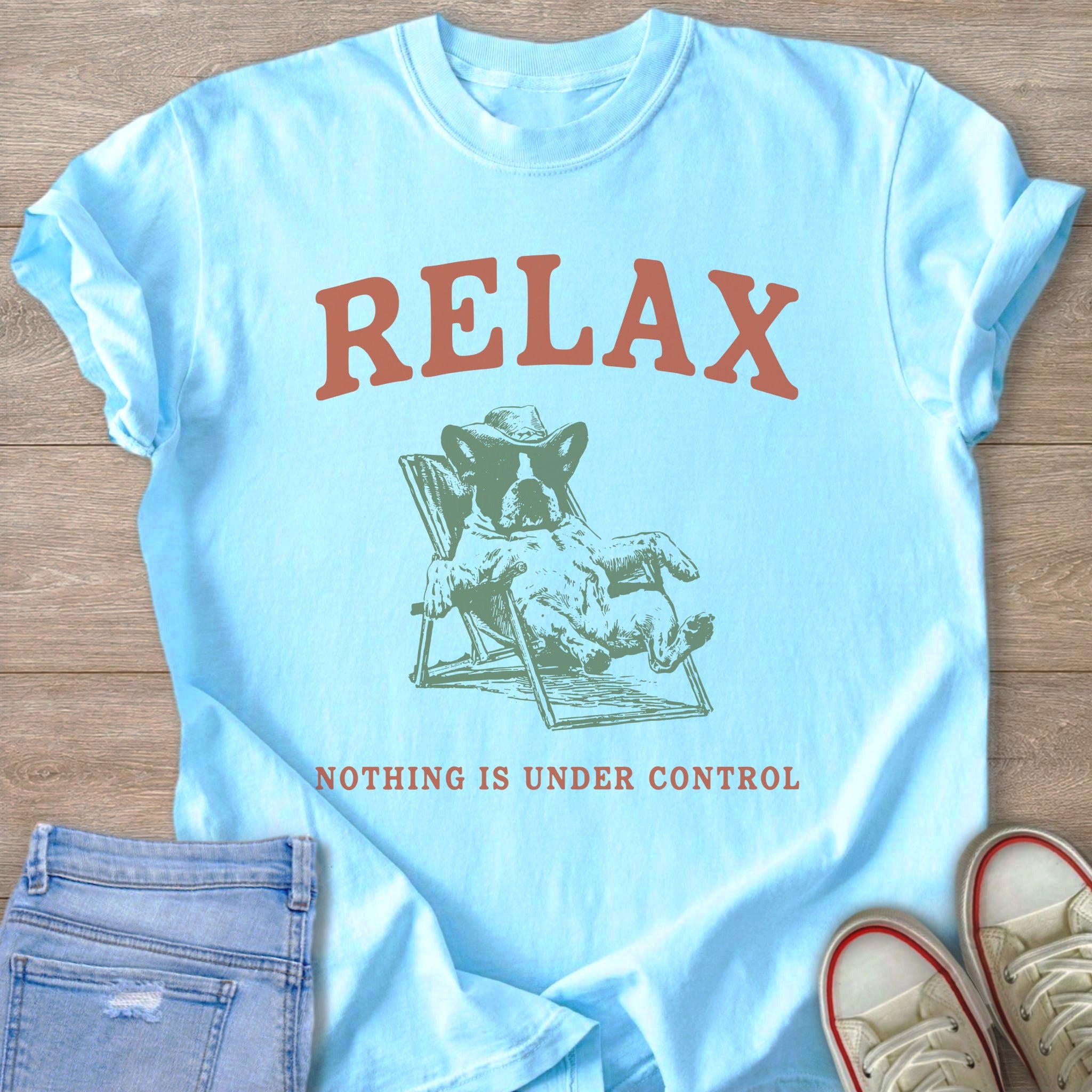 Light blue t-shirt with "RELAX" text and a dog in a lounge chair.