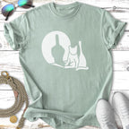 White cat silhouette with a middle finger shadow on a light green t-shirt.