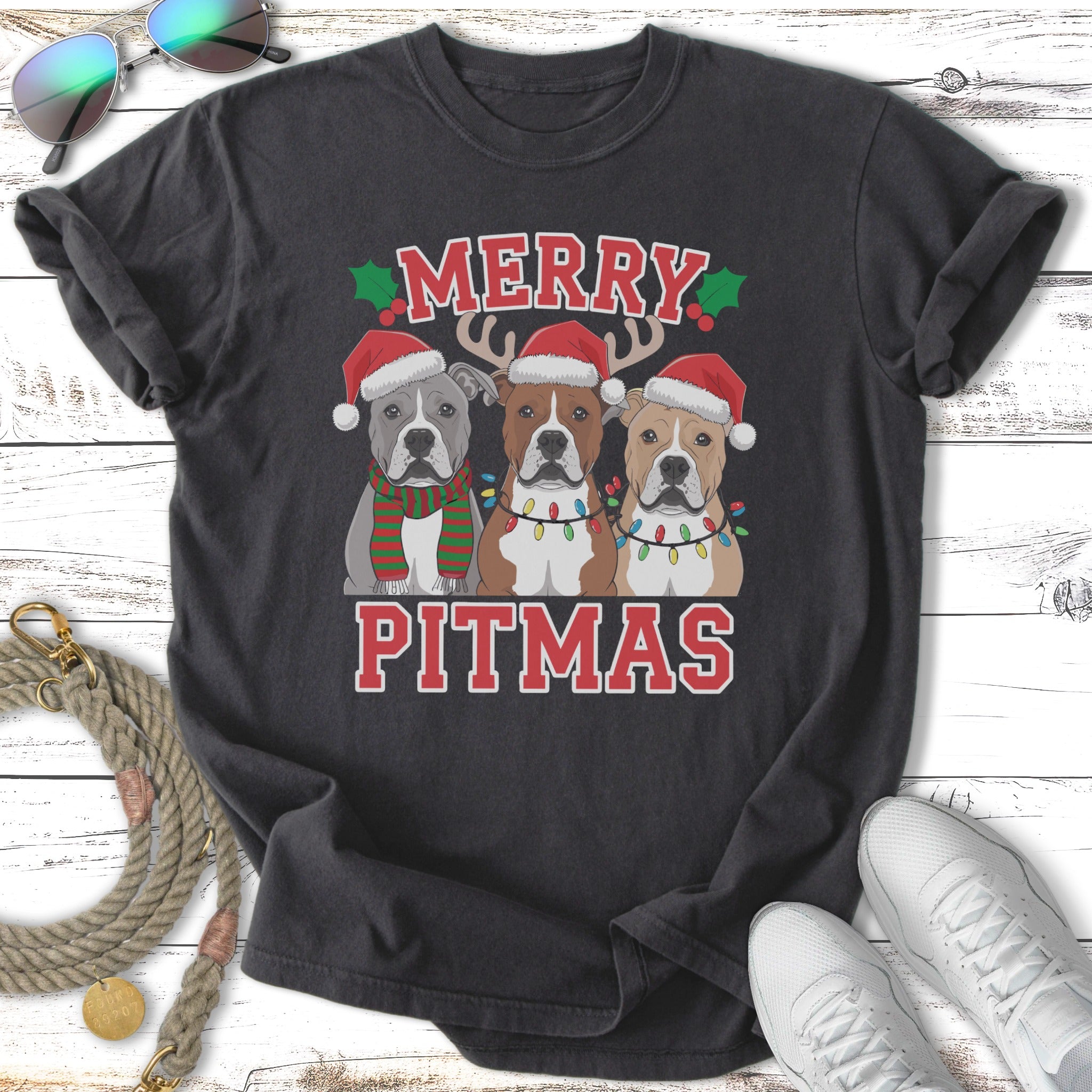 Three Pitbulls in Santa hats wearing Christmas lights and the text "Merry Pitmas".