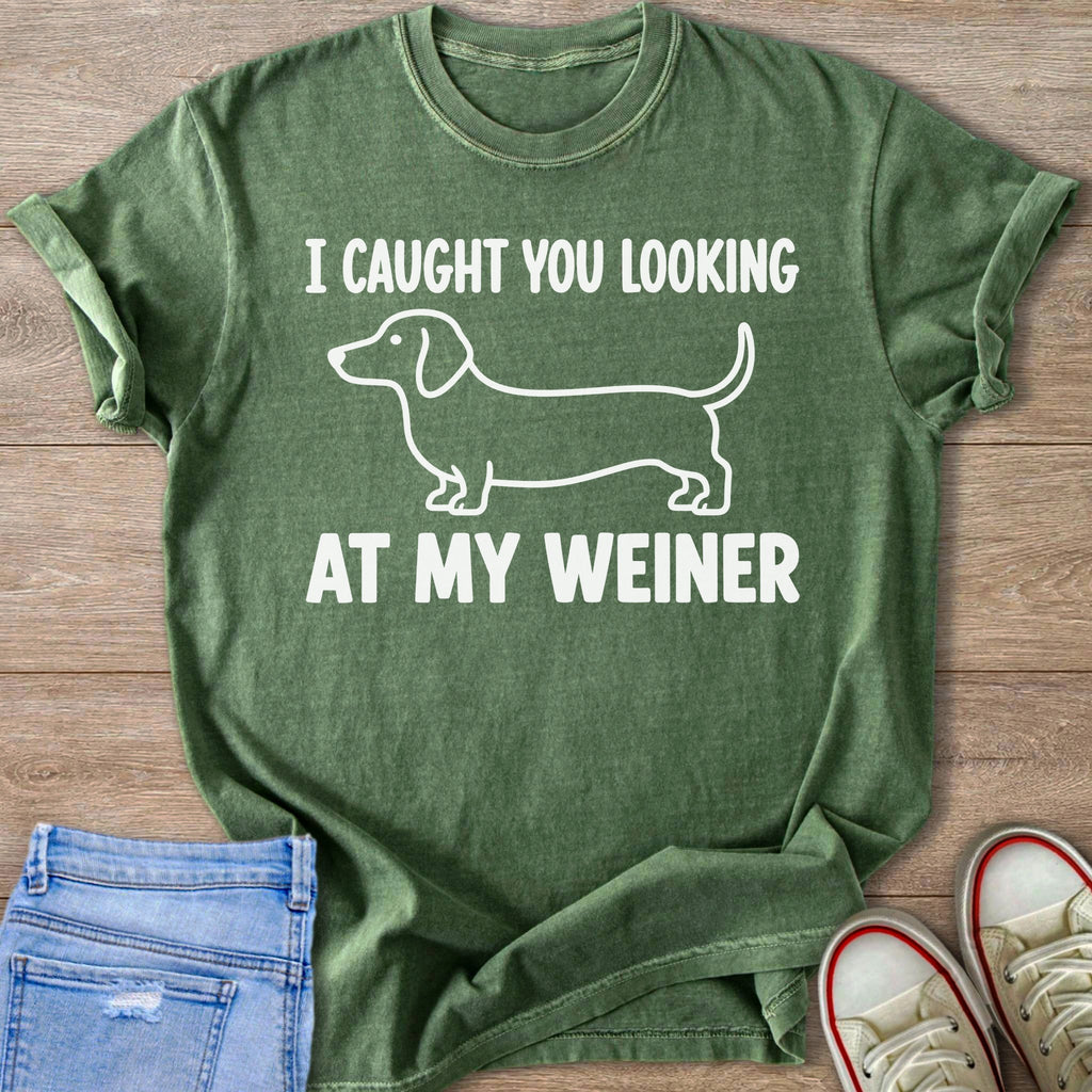 Green t-shirt with white outline of a dachshund and text reading "I CAUGHT YOU LOOKING AT MY WEINER".