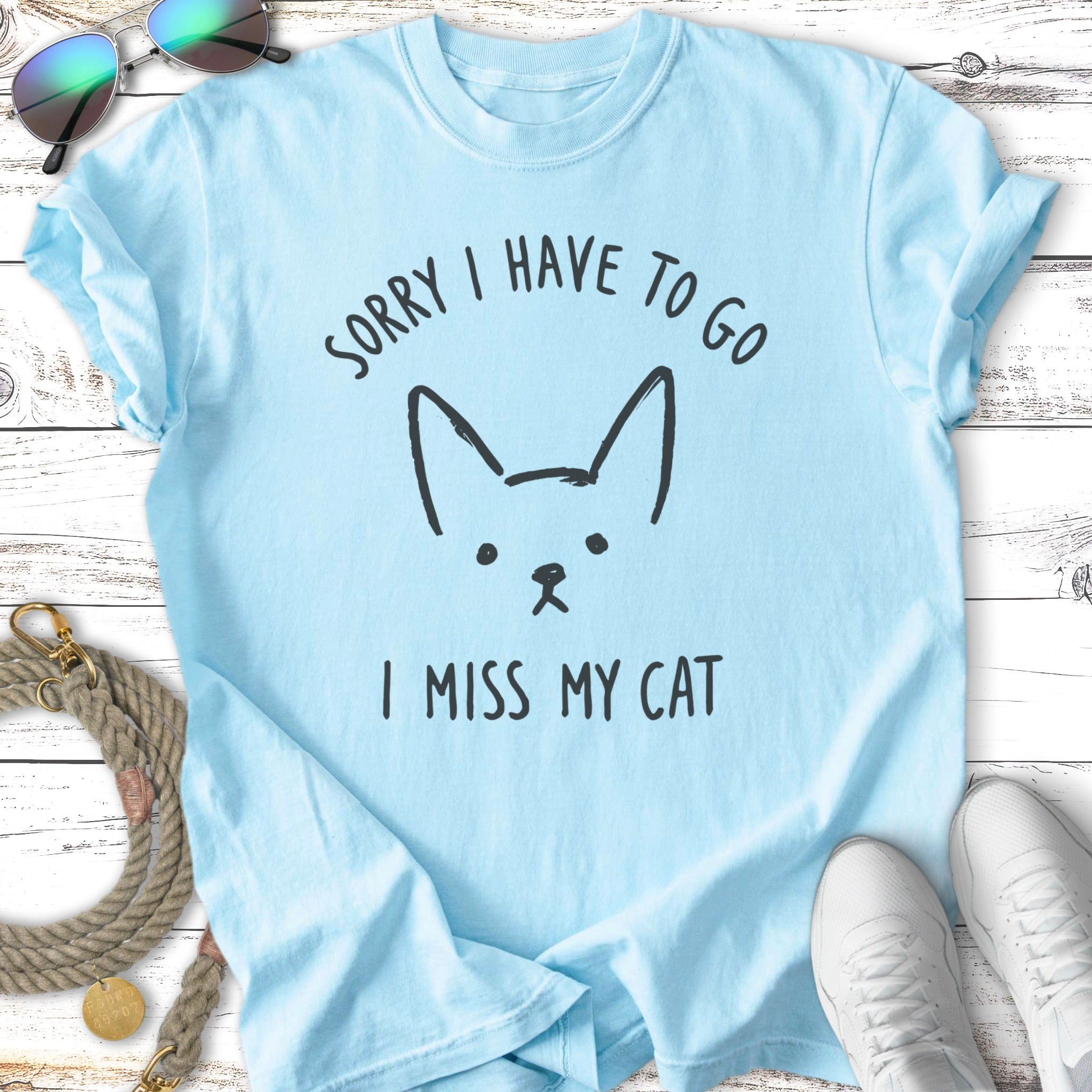 Light blue t-shirt with cat graphic and "SORRY I HAVE TO GO I MISS MY CAT" text.