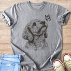 Grey t-shirt with line drawing of doodle dog looking up at a butterfly.