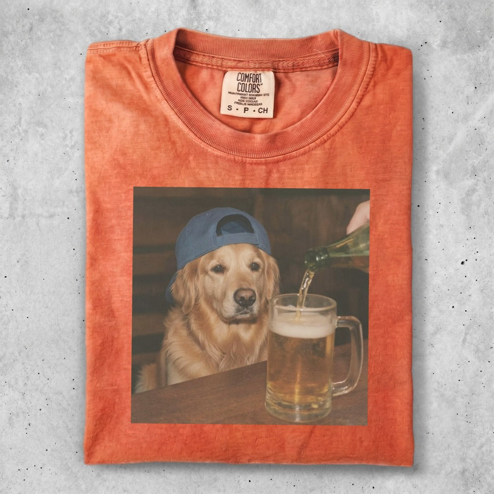 Golden Retriever wearing a blue baseball cap drinks from a beer mug.