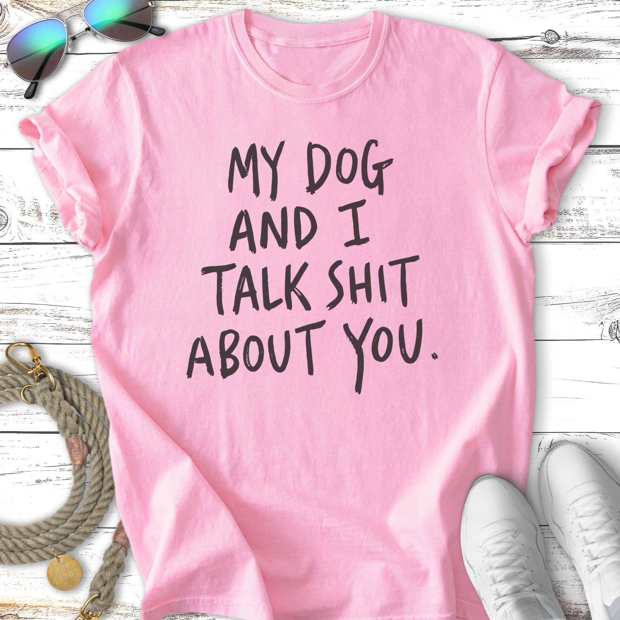 Pink t-shirt with "My dog and I talk shit about you." in black text.