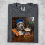 Dog in blue hat holding hot dog next to beer mug with American flag.