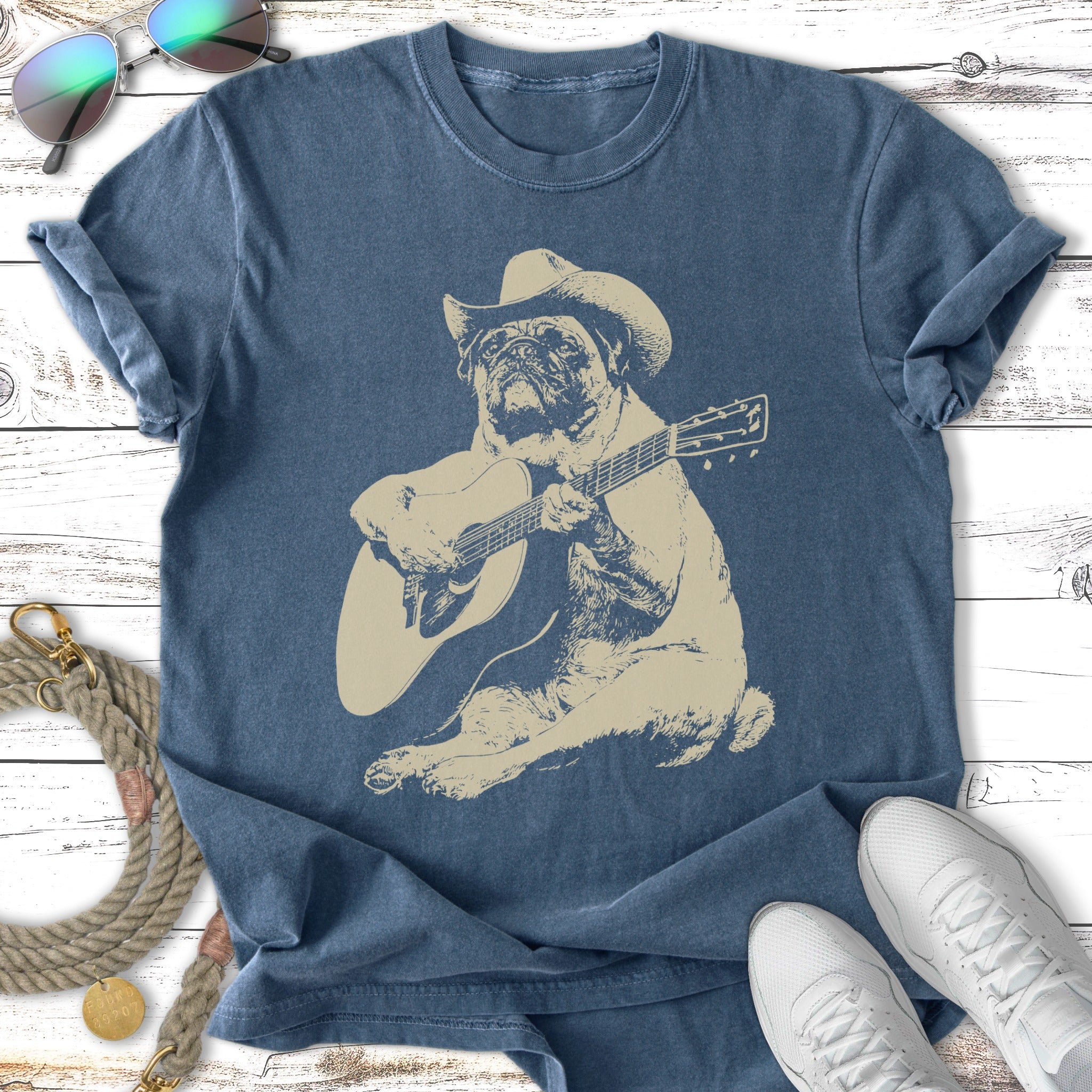 Pug wearing a cowboy hat playing an acoustic guitar.