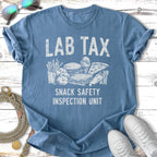 Blue t-shirt with text "LAB TAX SNACK SAFETY INSPECTION UNIT" and graphic icons.