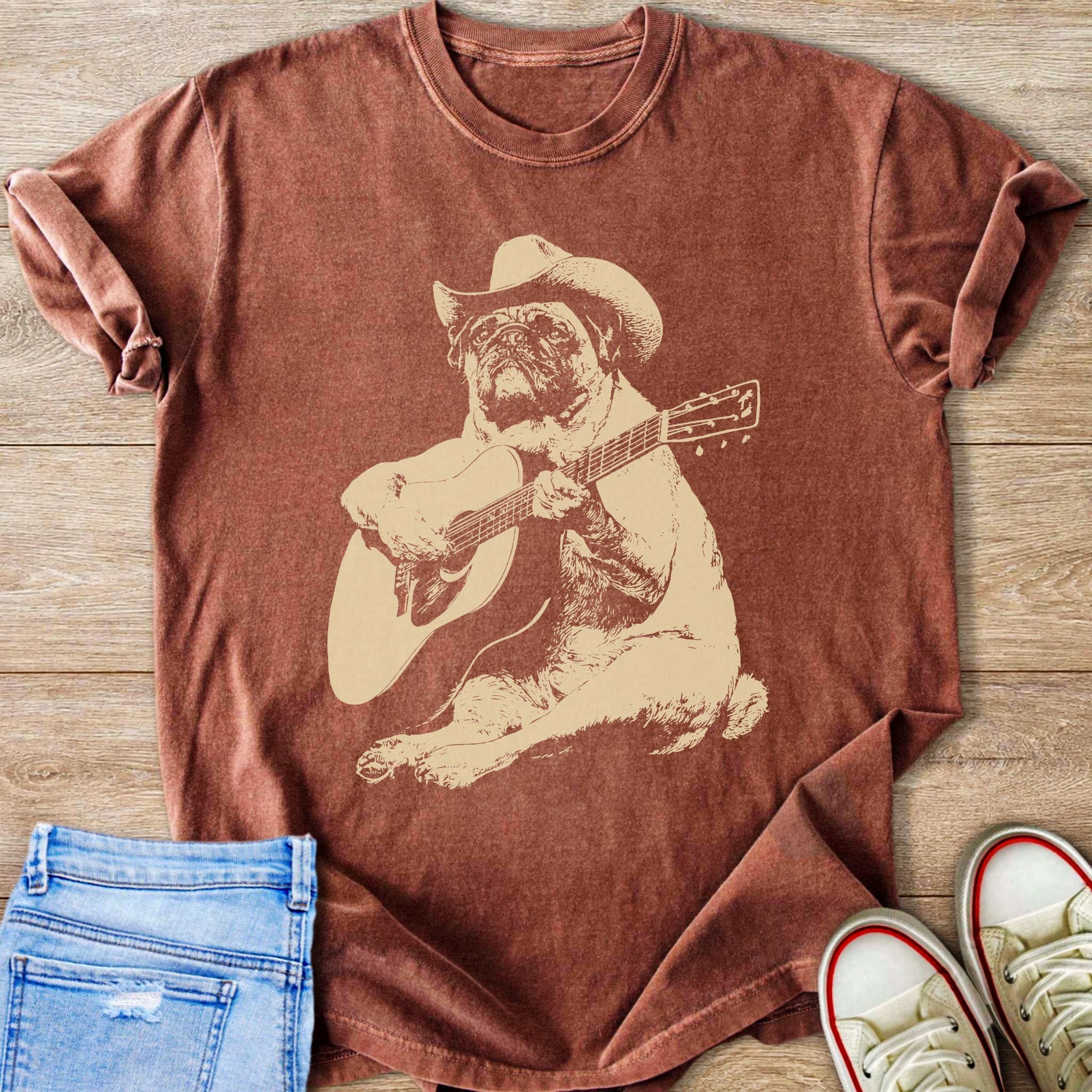 Brown t-shirt with a pug wearing a cowboy hat playing guitar graphic.