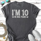 T-shirt with "I'M 10 IN DOG YEARS" text and paw prints.